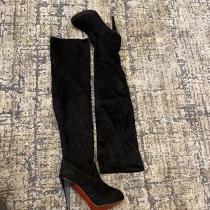 Black thigh high boots.